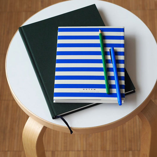 The planner features a minimalist design with a waterproof stripy bright blue and white softcover. The pages are made of high-quality paper that is smooth and acid-free, perfect for writing with any pen or pencil.