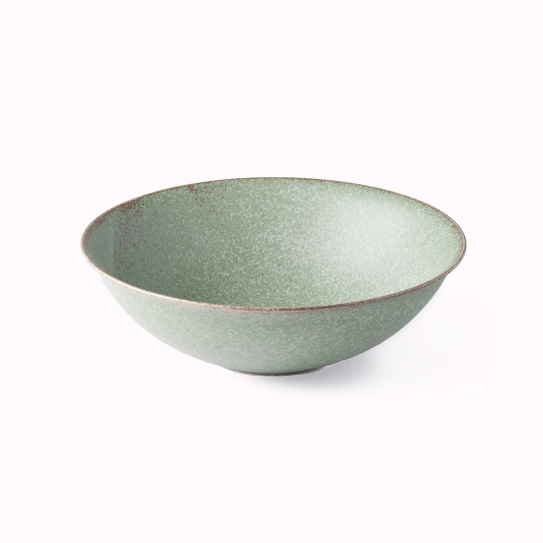 The Green Fade Glaze features a lush, forest green tone with button-flower blue highlights and an edge of light brown. Each piece has a unique dappled pattern determined by its position in the kiln during the firing process.