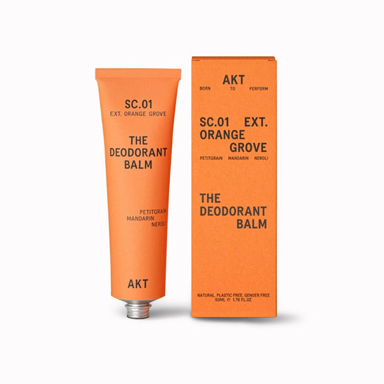 Deodorant balm tube and packaging with 'AKT' branding on a white background