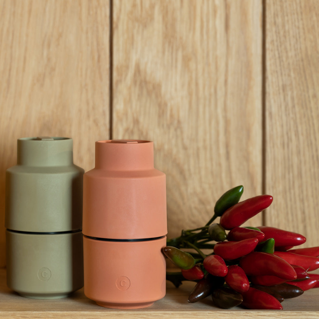 An earthy Papika coloured Danish designed Billund spice grinder from CrushGrind is a 12cm tall upside-down grinder with a powerful ceramic grinding module that makes easy work of grinding salt, pepper, dried herbs and most spices