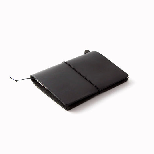 The Traveler's Notebook - Passport Size is a compact, passport‑sized notebook system built for personal organisation, journaling and creative planning. It pairs a handmade cowhide leather cover from Thailand with a blank MD paper insert crafted in Japan