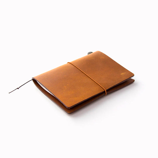The Traveler's Notebook - Passport Size is a compact, passport‑sized notebook system built for personal organisation, journaling and creative planning. It pairs a handmade cowhide leather cover from Thailand with a blank MD paper insert crafted in Japan