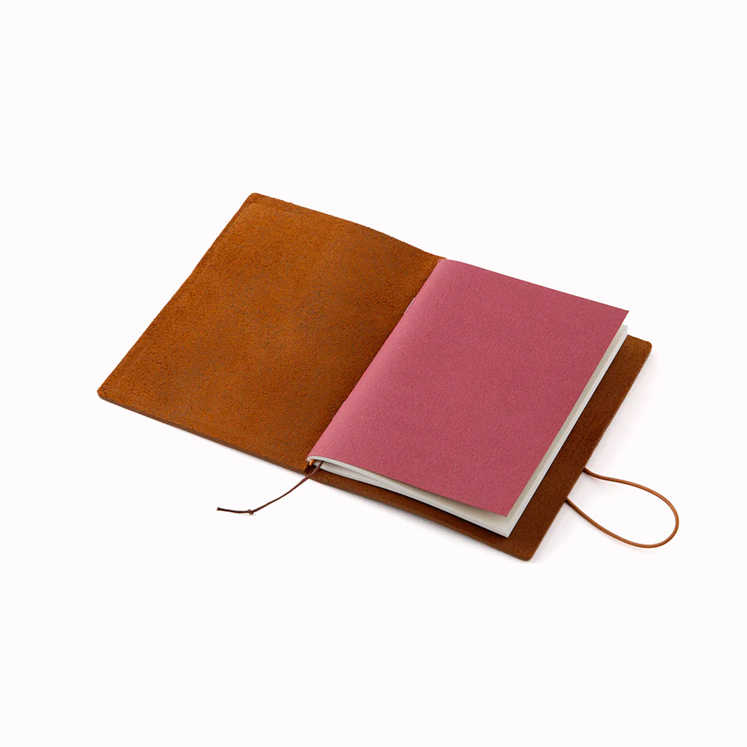 The Traveler's Notebook - Passport Size is a compact, passport‑sized notebook system built for personal organisation, journaling and creative planning. It pairs a handmade cowhide leather cover from Thailand with a blank MD paper insert crafted in Japan