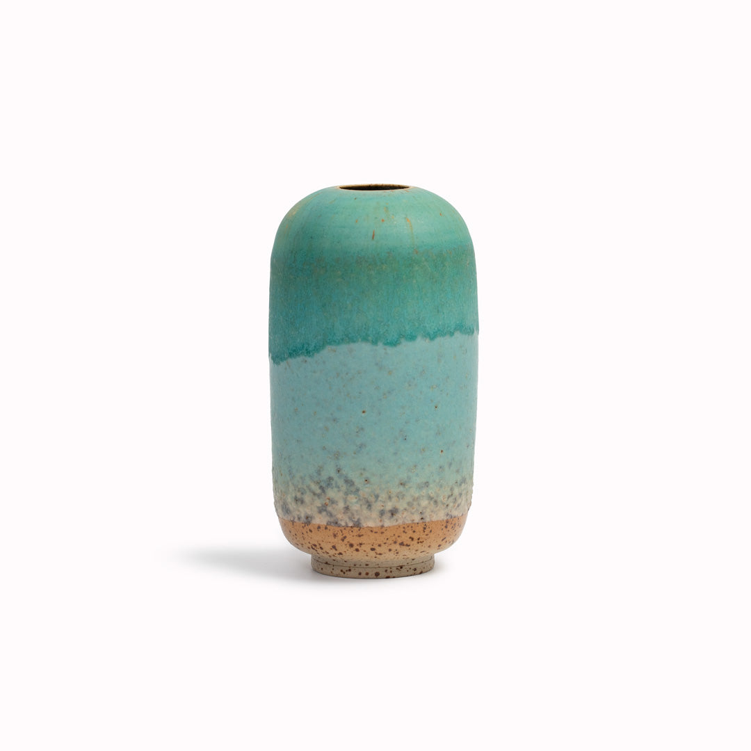 The Pebble Beach&nbsp;design is hand-thrown in watertight stoneware. Due to the rounded taper at the top of the vase, the glaze melts down the sides of the cylindrical vase mimicking melting ice.
