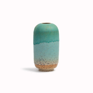 The Pebble Beach&nbsp;design is hand-thrown in watertight stoneware. Due to the rounded taper at the top of the vase, the glaze melts down the sides of the cylindrical vase mimicking melting ice.
