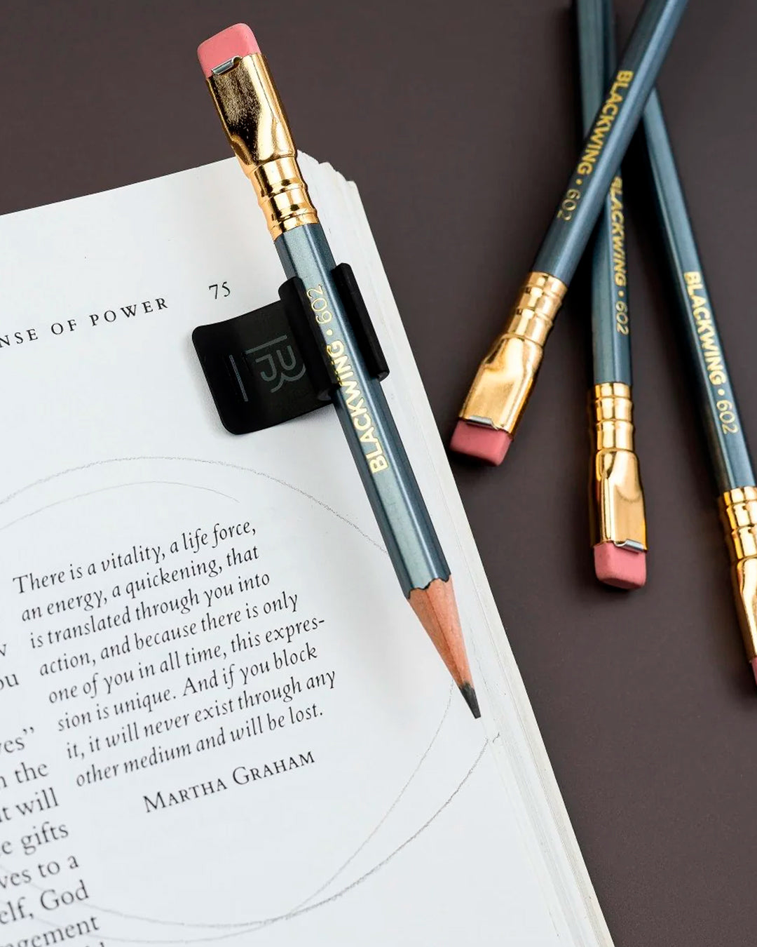 The Blackwing Pencil Holder is a simple metal clip designed to attach securely to the cover of your favourite notebook, giving your pencil a dedicated place to live.