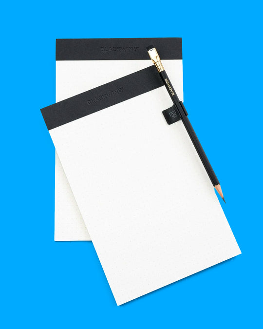 The Blackwing Pencil Holder is a simple metal clip designed to attach securely to the cover of your favourite notebook, giving your pencil a dedicated place to live.