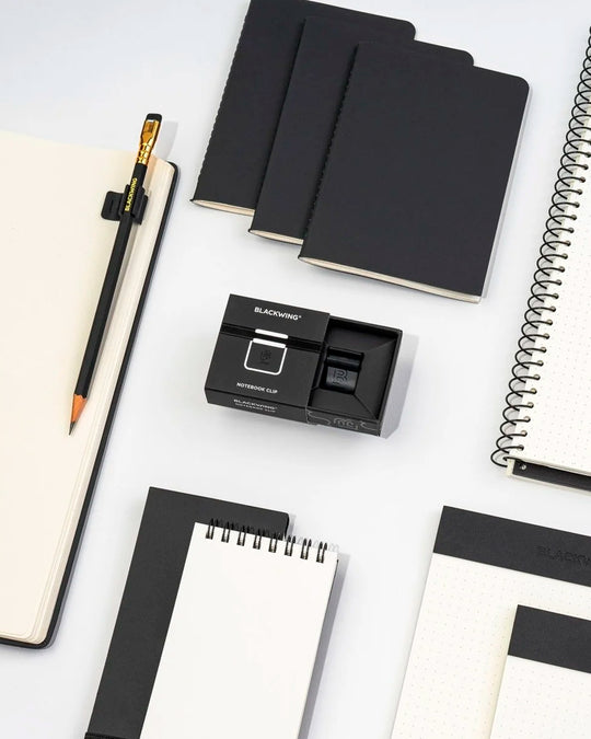 The Blackwing Pencil Holder is a simple metal clip designed to attach securely to the cover of your favourite notebook, giving your pencil a dedicated place to live.