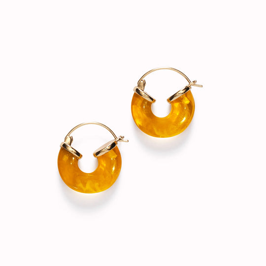 The Petit Swell Amber Hoops from Anni Lu highlight the brand's commitment to craftsmanship and style.