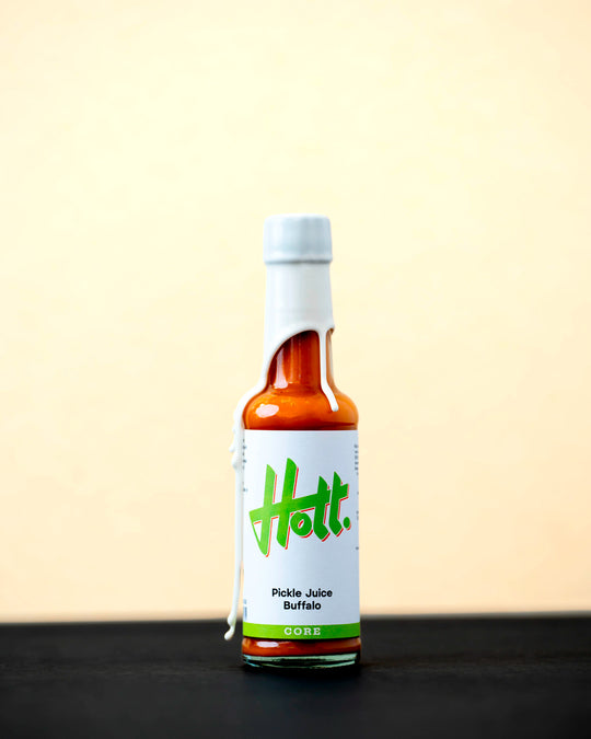 Hott Buffalo Pickle Juice has a medium buttery heat with a complex roasted garlic depth.
