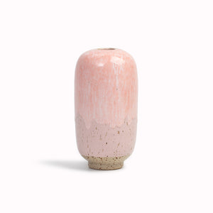 The Pink Melt&nbsp;design is hand-thrown in watertight stoneware. Due to the rounded taper at the top of the vase, the glaze melts down the sides of the cylindrical vase mimicking melting ice.