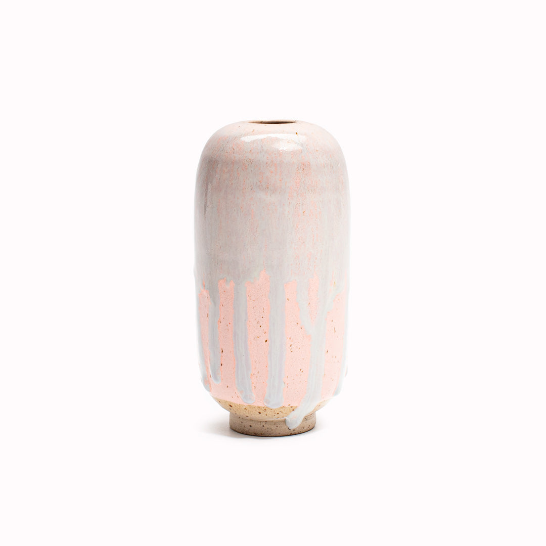 The Pink Melt design is hand-thrown in watertight stoneware. Due to the rounded taper at the top of the vase, the glaze melts down the sides of the cylindrical vase mimicking melting ice.