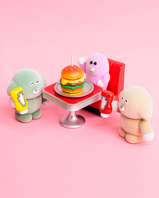 Six fuzzy Pokkoshi characters are hanging out at the diner, accompanied by miniature food, furniture and accessories including burgers, shakes, diner seating and more