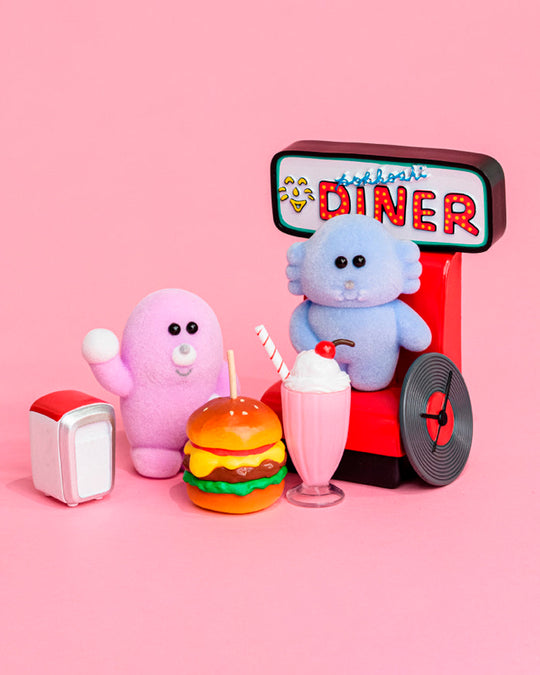 Six fuzzy Pokkoshi characters are hanging out at the diner, accompanied by miniature food, furniture and accessories including burgers, shakes, diner seating and more