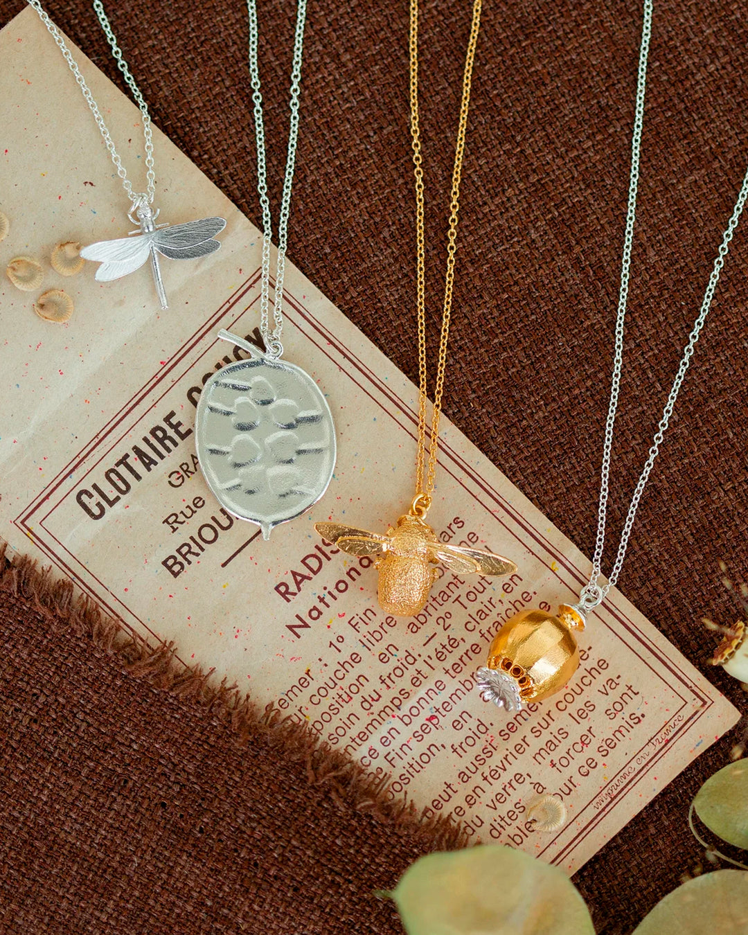 Large Poppy Head Necklace is a stunning sculptural botanical necklace in a mix of silver and gold plated metals. Inside the necklace are tiny silver ball 'shaking seeds' for a subtle sound feature.&nbsp;