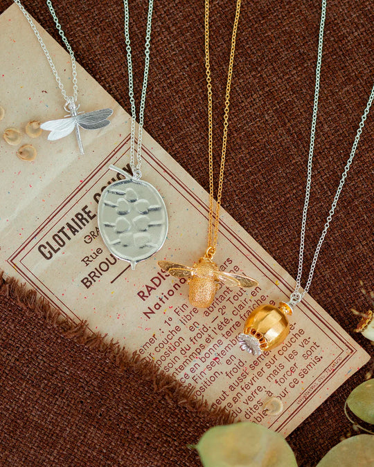 Large Poppy Head Necklace is a stunning sculptural botanical necklace in a mix of silver and gold plated metals. Inside the necklace are tiny silver ball 'shaking seeds' for a subtle sound feature.&nbsp;