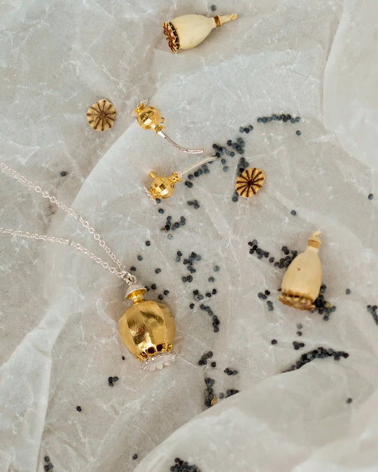 Large Poppy Head Necklace is a stunning sculptural botanical necklace in a mix of silver and gold plated metals. Inside the necklace are tiny silver ball 'shaking seeds' for a subtle sound feature.&nbsp;