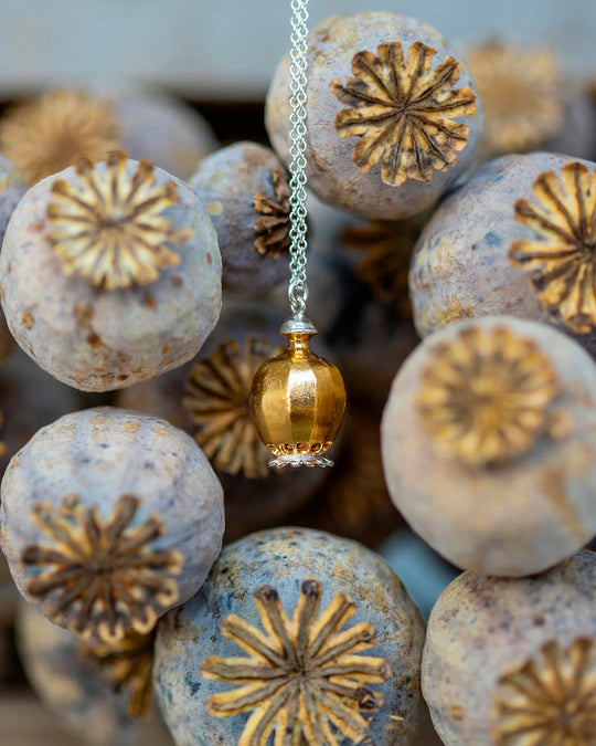 Large Poppy Head Necklace is a stunning sculptural botanical necklace in a mix of silver and gold plated metals. Inside the necklace are tiny silver ball 'shaking seeds' for a subtle sound feature.&nbsp;