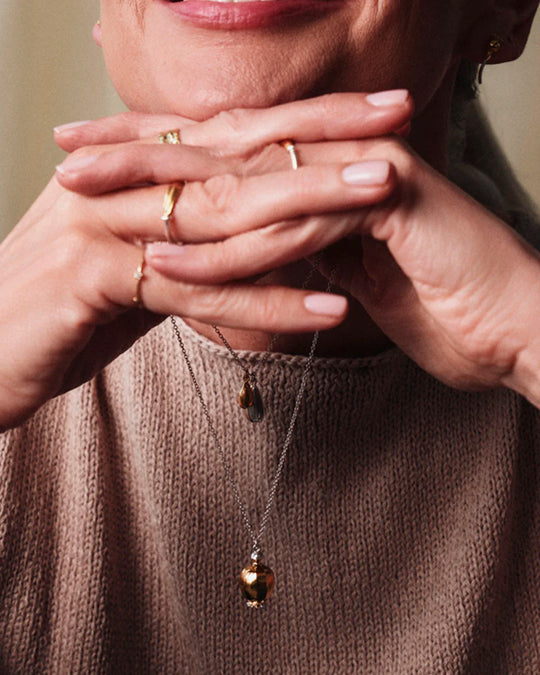 Large Poppy Head Necklace is a stunning sculptural botanical necklace in a mix of silver and gold plated metals. Inside the necklace are tiny silver ball 'shaking seeds' for a subtle sound feature.&nbsp;