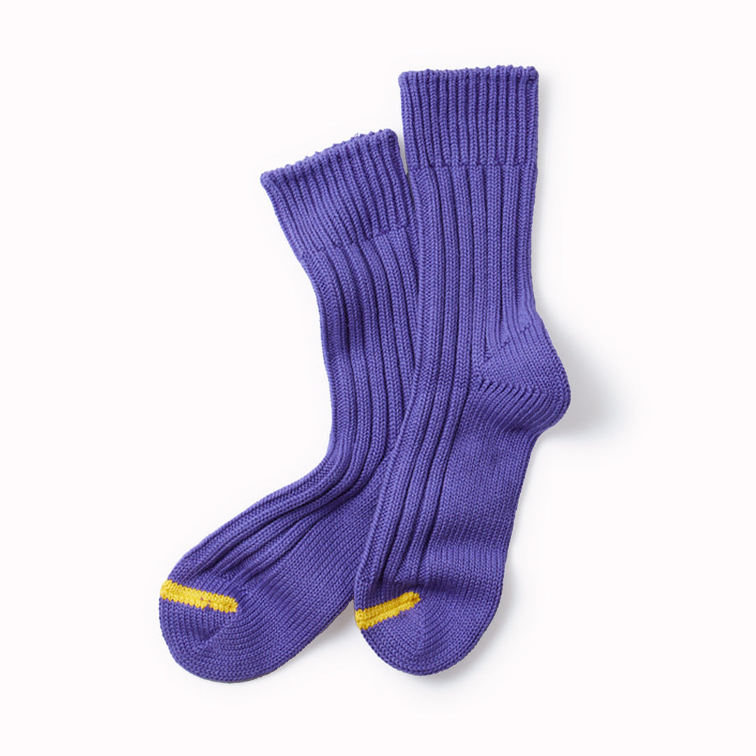 Premium Japanese cotton chunky organic cotton ribbed socks that are knitted on a traditional, non computerised knitting machine. Thick and comfortable with long-lasting quality, with excellent breathability due to the chunky rib stitch.  Purple socks with a contrasting stripe across the toe.