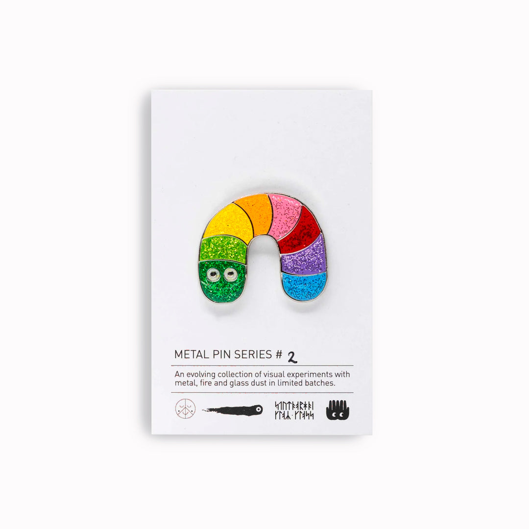 A limited edition collectible Rainbow Worm design pin badge by Studio Arhoj, from their Series 2 edition. This design comes with added sparkle, using a glitter enamel