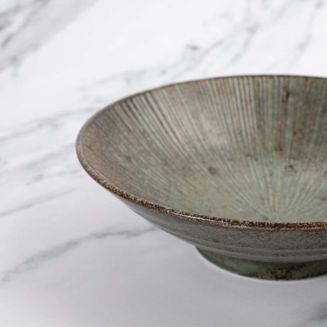 A stunning Japanese Mino ware Ramen bowl featuring a matt green glaze with striking dark green etched lines.