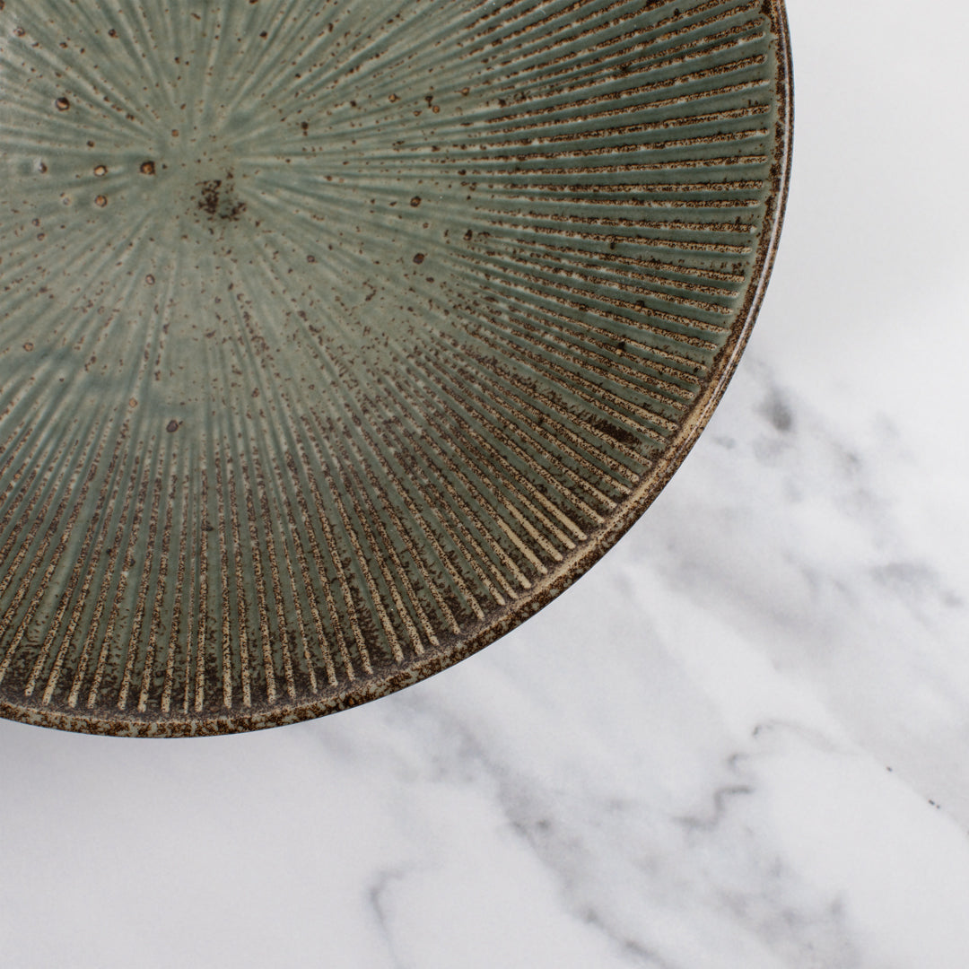 A stunning Japanese Mino ware Ramen bowl featuring a matt green glaze with striking dark green etched lines.