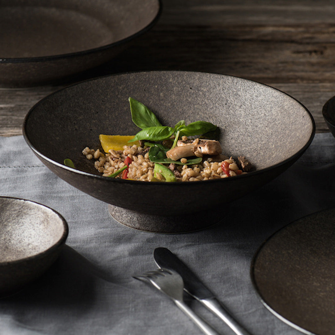 The Earth range features a unique glaze with rustic tones with a focus on simple texture. When turned toward to the light, it shimmers silver - Perfect for noodles, the bowl is around 8cm high and 24cm in diameter.