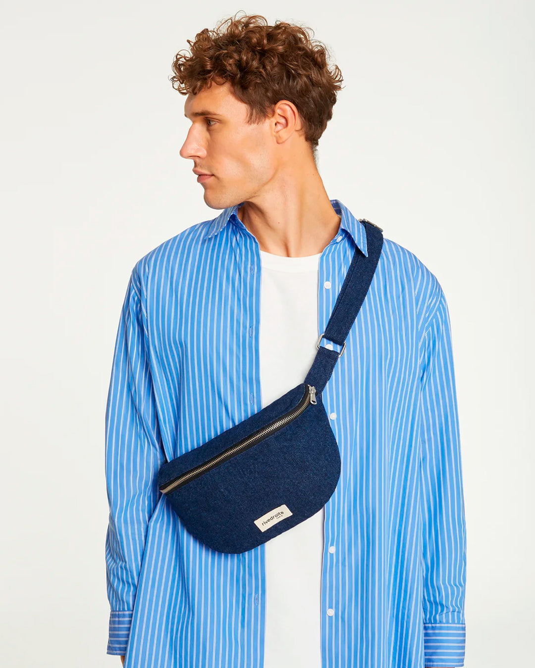 The Custine Belt Bag is a stylish and practical accessory crafted from upcycled raw denim. Designed by Rive Droite, a brand known for its commitment to sustainable fashion