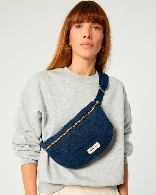The Custine Belt Bag is a stylish and practical accessory crafted from upcycled raw denim. Designed by Rive Droite, a brand known for its commitment to sustainable fashion