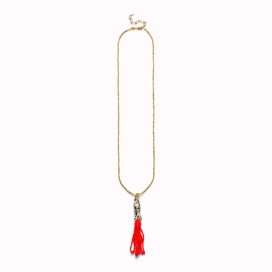 Tassel Fishy is a playful pendant necklace built around a long, fluid tassel form.