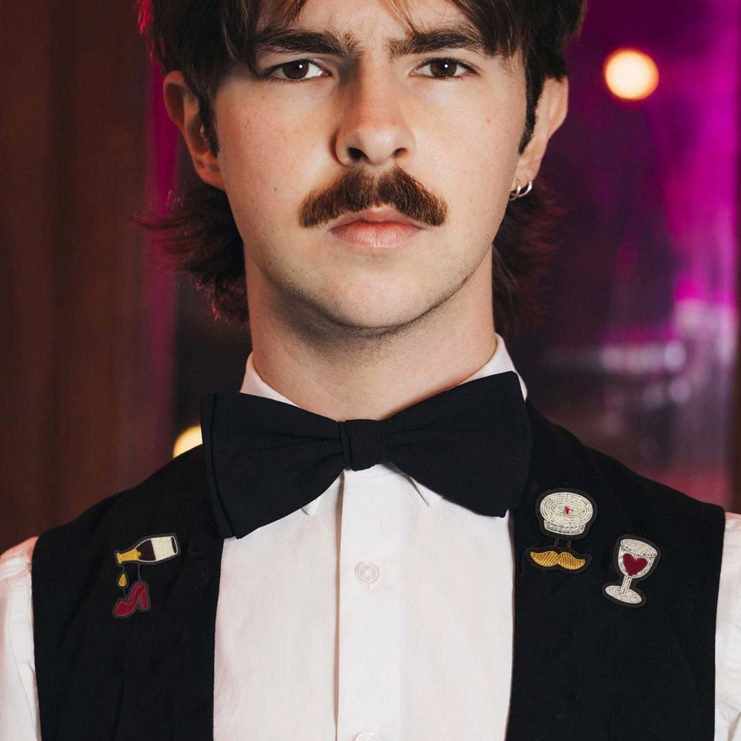 Hand-embroidered 'Red Wine Love' design lapel pin by Parisian fashion accessory brand Macon et Lesquoy. Measures approximately 33mm by 20mm.