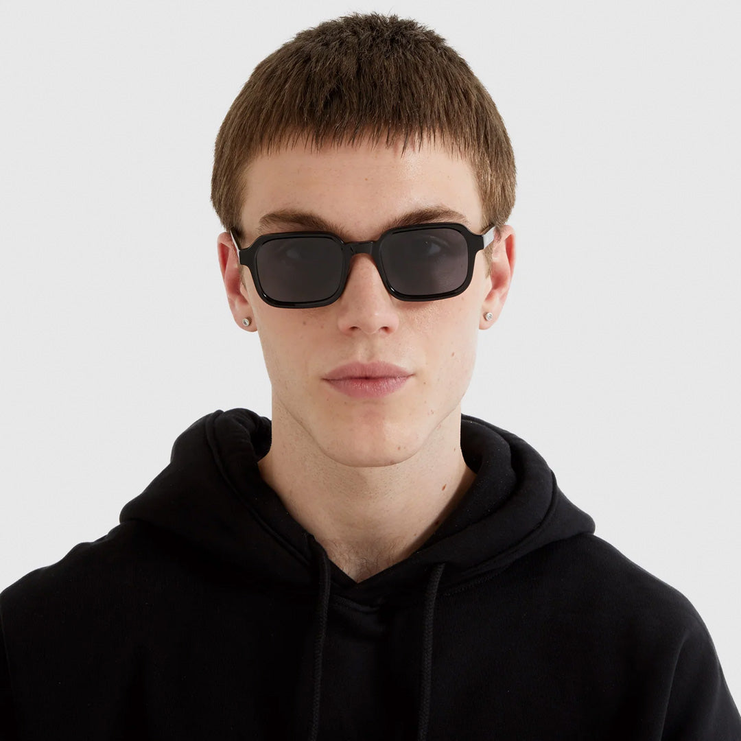 Romeo Black as worn by model, The perfect combination of cool and comfort: the Romeo is a no-nonsense style. Your perfect partner in crime during this summer. With a black Recycled Acetate frame and solid smoke lenses, these sunglasses will keep you looking stylish and cool in any situation.