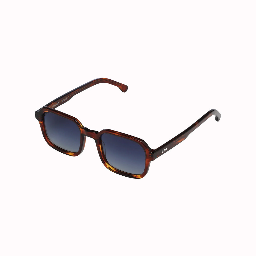 The perfect combination of cool and comfort: the Romeo is a no-nonsense style. Your perfect partner in crime during this summer. Sideways View. The Romeo Bourbon features a golden brown mottled frame with gradient blue lenses for a subtle contrast. Keep your cool in any situation with these stylish sunglasses.