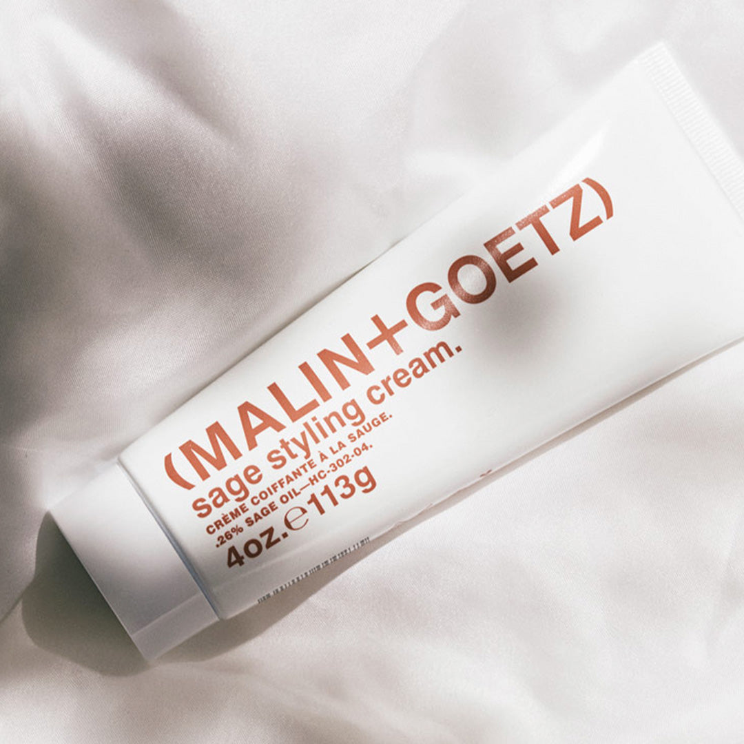 The Sage Hair Styling Cream by Malin+Goetz is a versatile product designed to suit all hair types, offering a flexible hold that adds shine and definition while taming frizz.