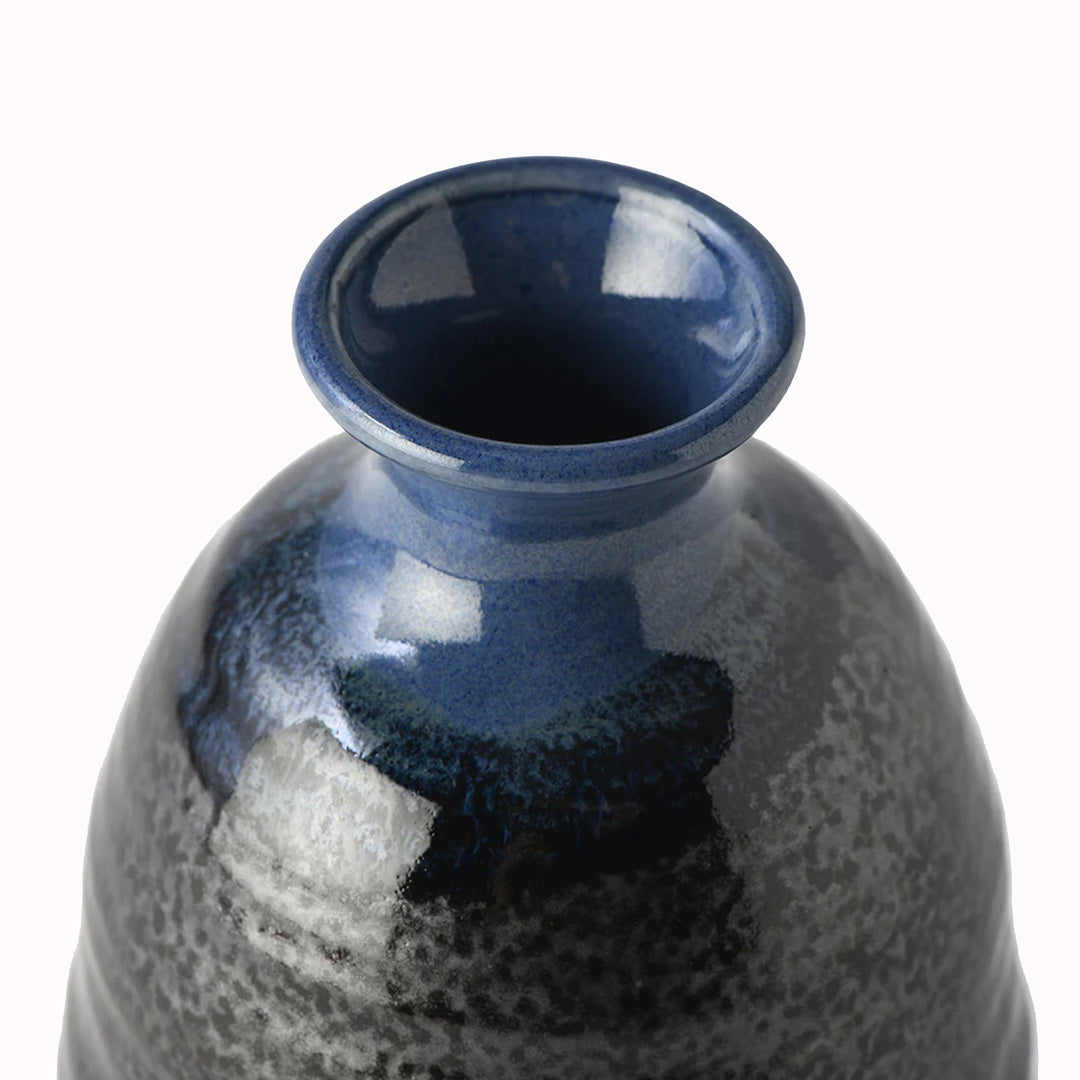 Detail - Japanese Sake jug featuring a black glaze with a dark blue top.