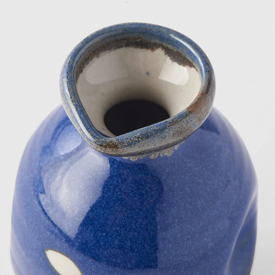 A decorative Japanese Sake jug with decorative kanji (meaning 'Japan') in a dark blue glaze with white Kanji.