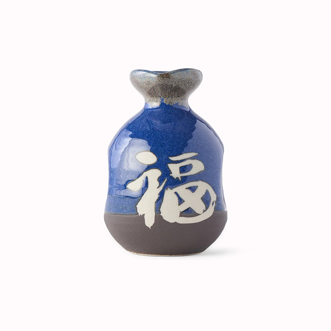 A decorative Japanese Sake jug with decorative kanji (meaning 'Japan') in a dark blue glaze with white Kanji.