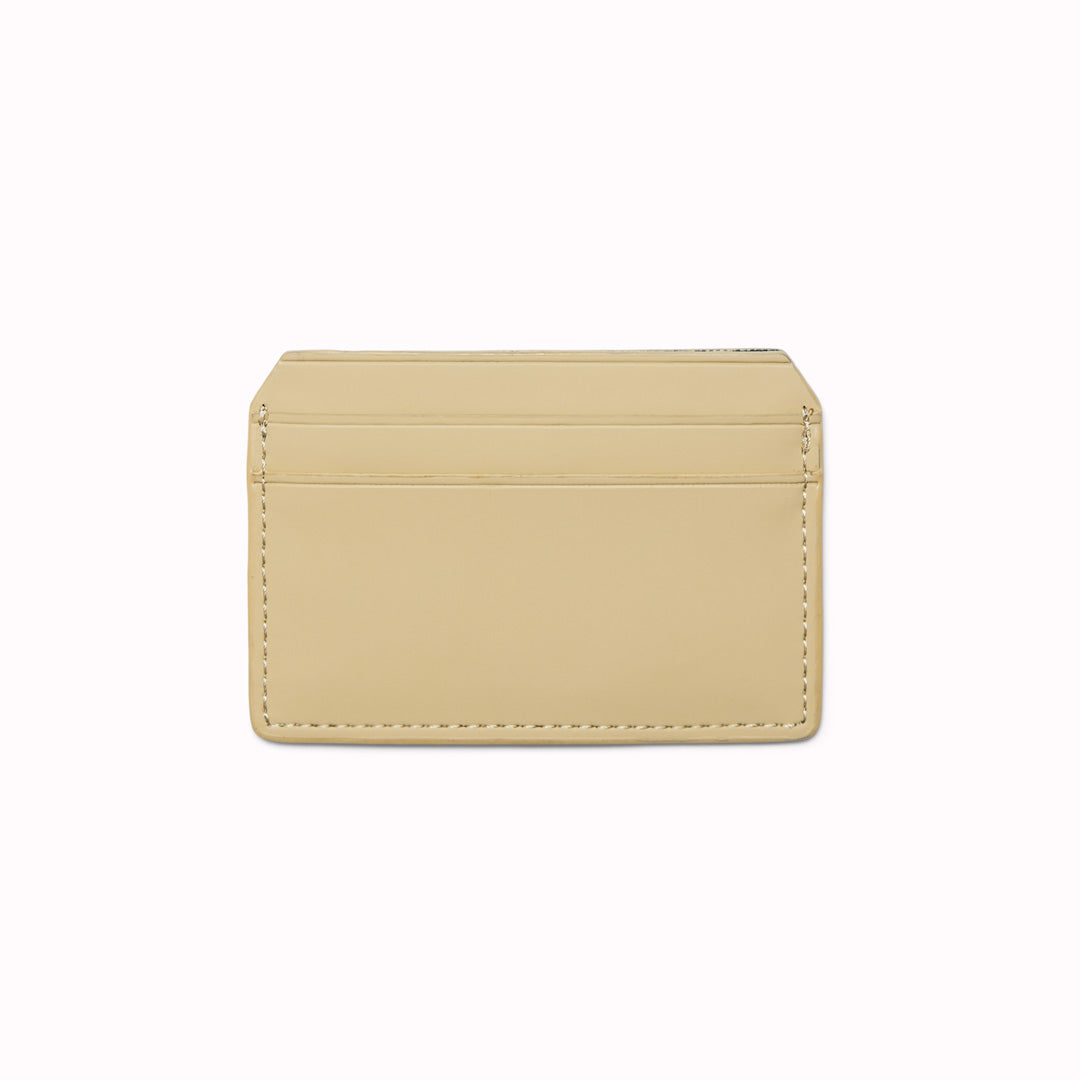 The Card Holder in Sand is crafted from Rains’ signature water-resistant fabric with a matte finish, engineered for strength, durability and smooth feel. Their minimal take on the credit card wallet. A vegan card holder with four card slots, two on each side, with a central slot for more cards or cash notes. 