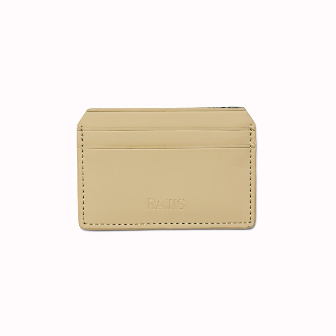 The Card Holder in Sand is crafted from Rains’ signature water-resistant fabric with a matte finish, engineered for strength, durability and smooth feel. Their minimal take on the credit card wallet. A vegan card holder with four card slots, two on each side, with a central slot for more cards or cash notes. 