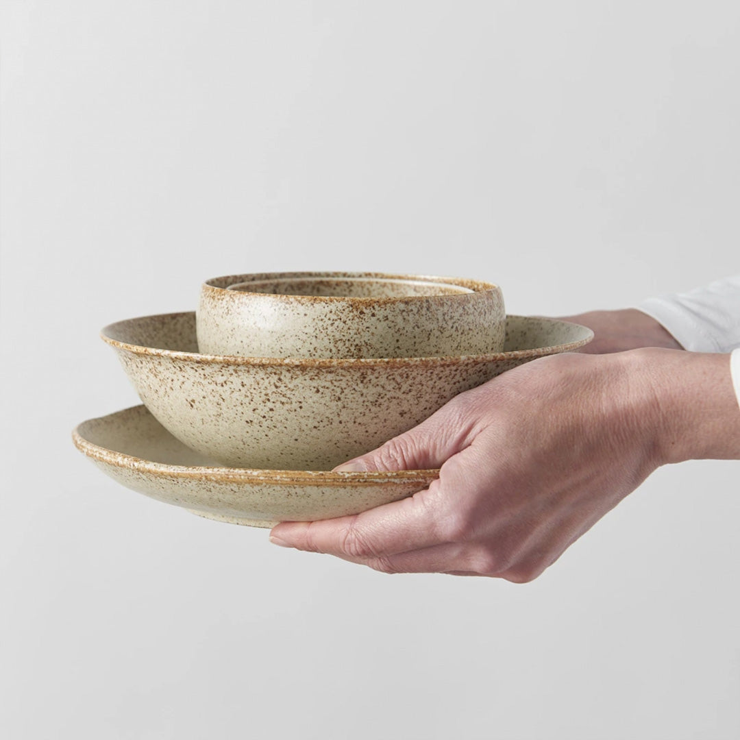 A small deep U shaped bowl made from 'Minoyaki' porcelain to mix and match with other pieces from the Sand Fade tableware collection. 13cm diameter and 7.5cm high