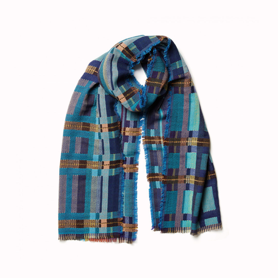 The Sedge Aqua lambswool scarf by Wallace and Sewell showcases the intricate craft of textile design, blending traditional techniques with modern aesthetics.