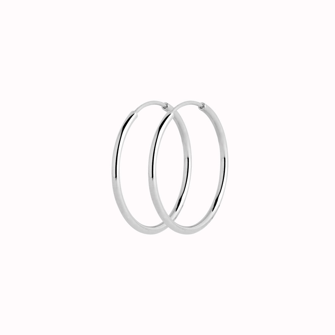 These Classic hoops from Maria Black are made from Sterling Silver and available with either White Rhodium plating or 22k Gold Plate.