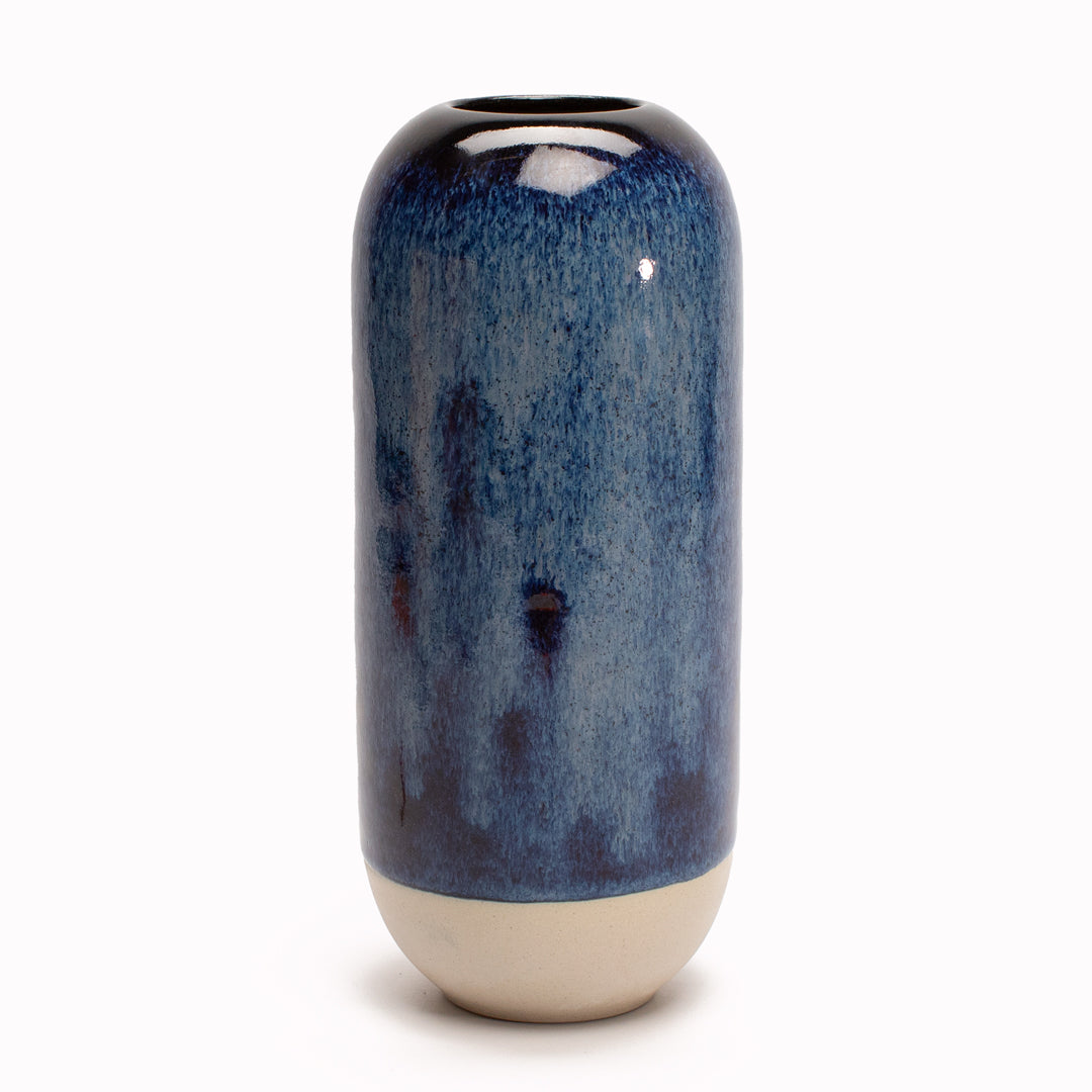 Shadow Blue is a deep blue hued Yuki Ceramic Vase that is drip glazed and hand-thrown in watertight stoneware.