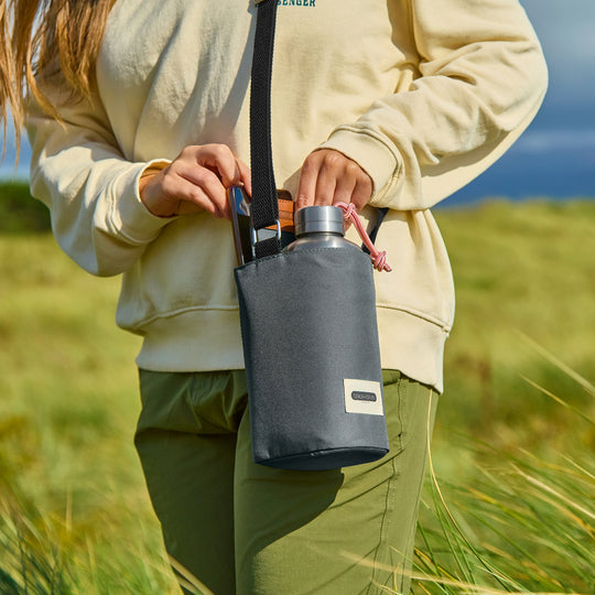 This insulated bottle bag in slate from Black+Blum is a practical, everyday carrier that keeps your bottle cool and your hands free. 