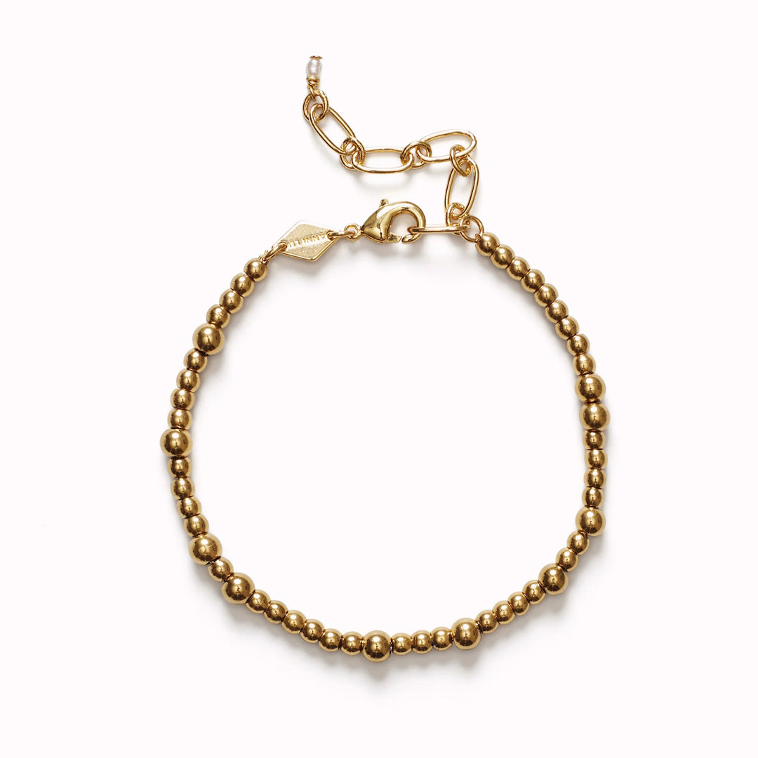 The Anni Lu Slim Goldie bracelet is a versatile piece of jewellery that offers a classic look when worn alone and layers with other pieces