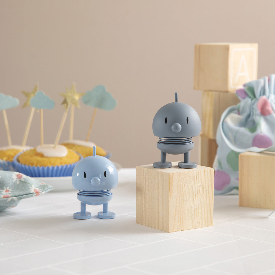 Playfully designed small Hoptimist in light blue from the Danish designers Hoptimist. Most smiles are triggered by another smile.