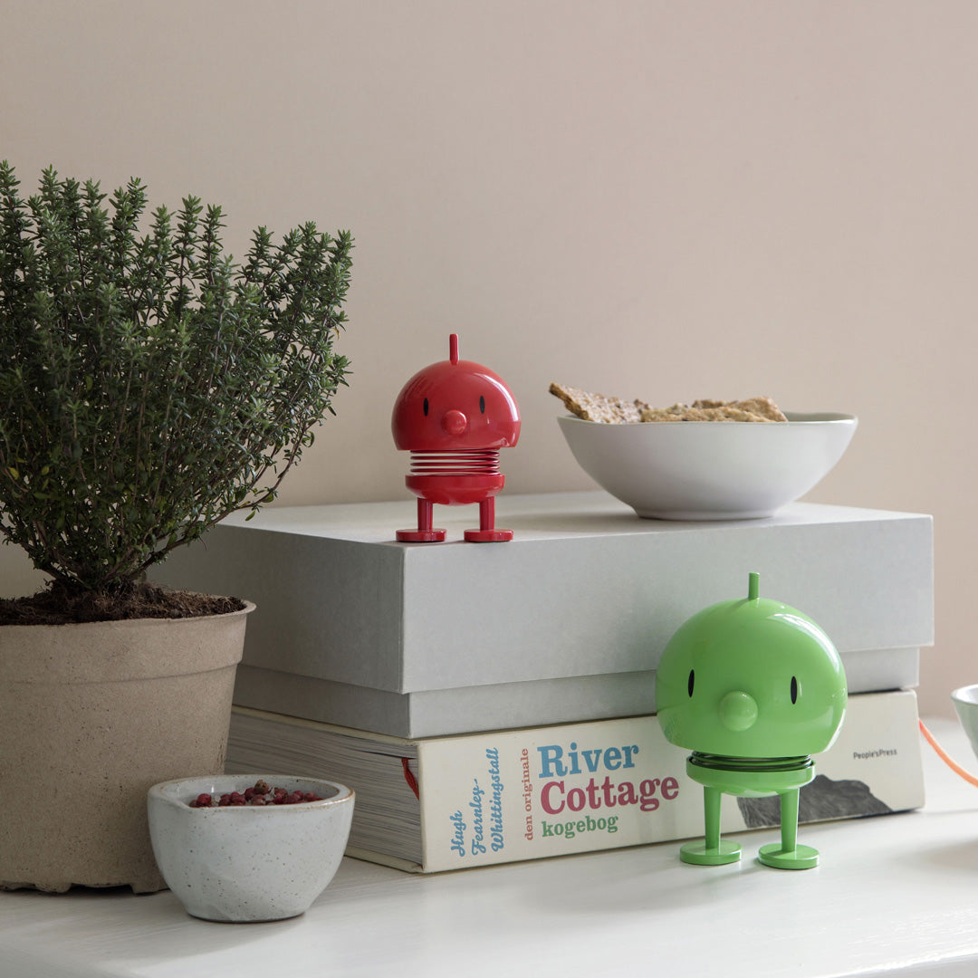 Playfully designed small Hoptimist in red from the Danish designers Hoptimist. Most smiles are triggered by another smile.