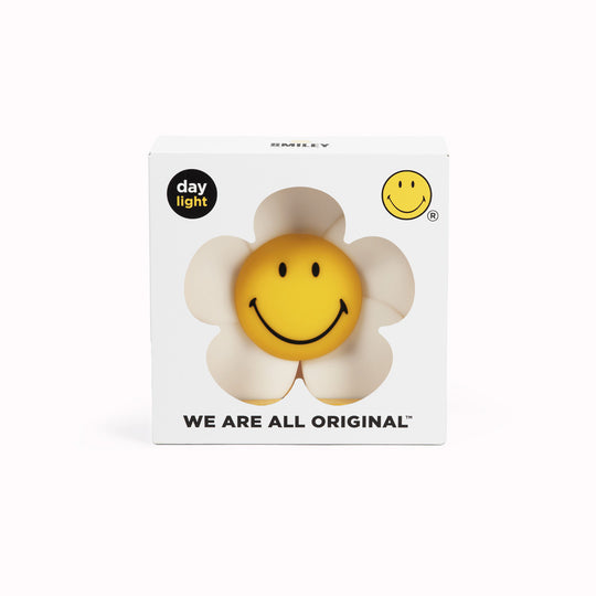 The Mr Maria Smiley Daisy lamp is a delightful addition to any room, offering not just illumination but also a touch of timeless joy with the Smiley brand - pictured with box