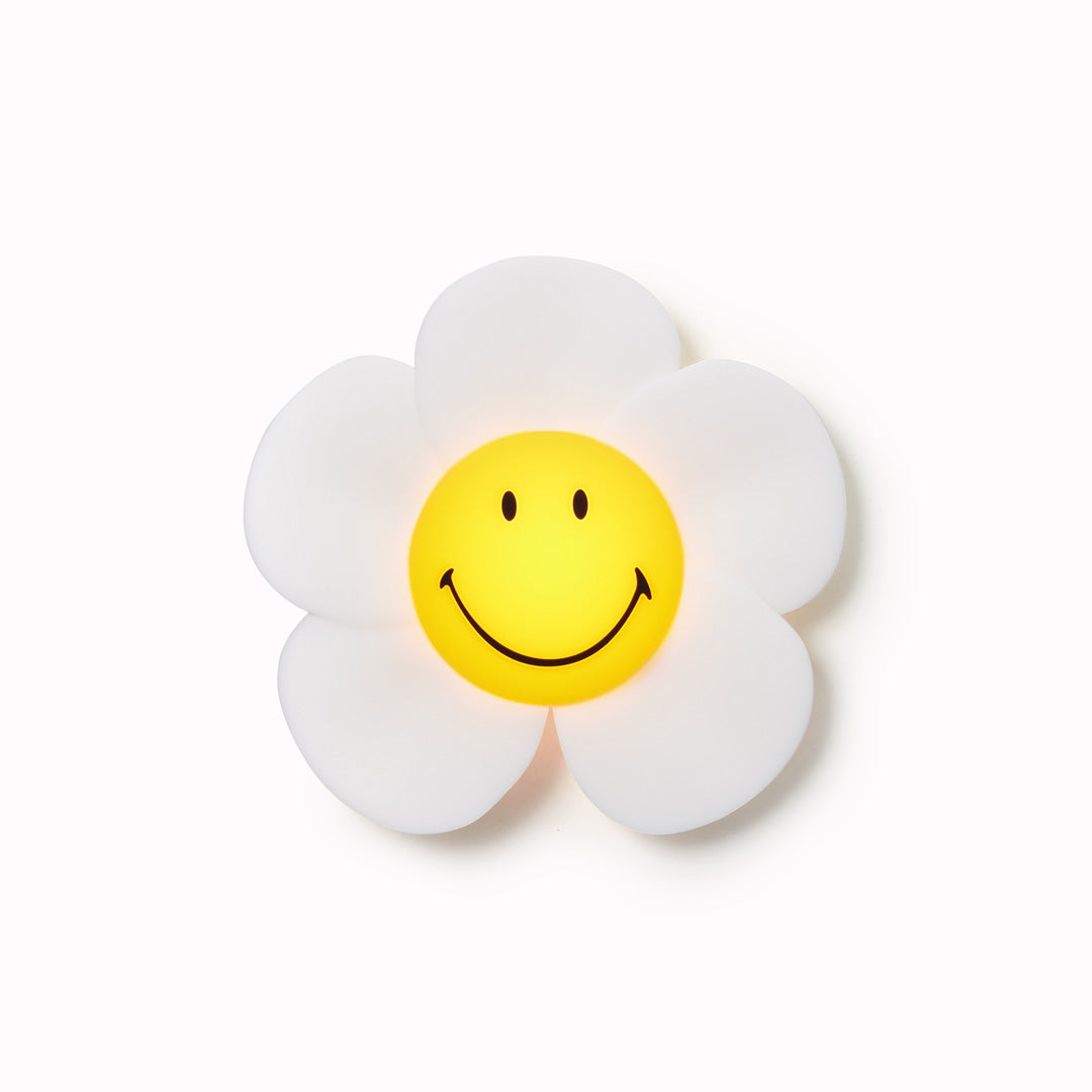 The Mr Maria Smiley Daisy lamp is a delightful addition to any room, offering not just illumination but also a touch of timeless joy with the Smiley brand - Pictured on